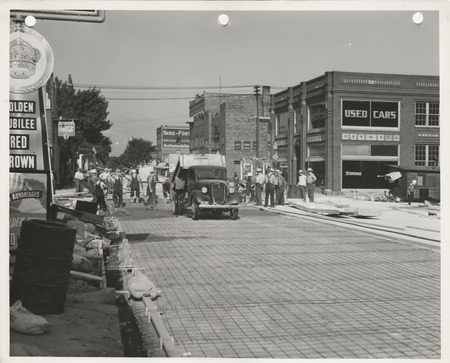 Photograph of people paving the street in Fort Dodge